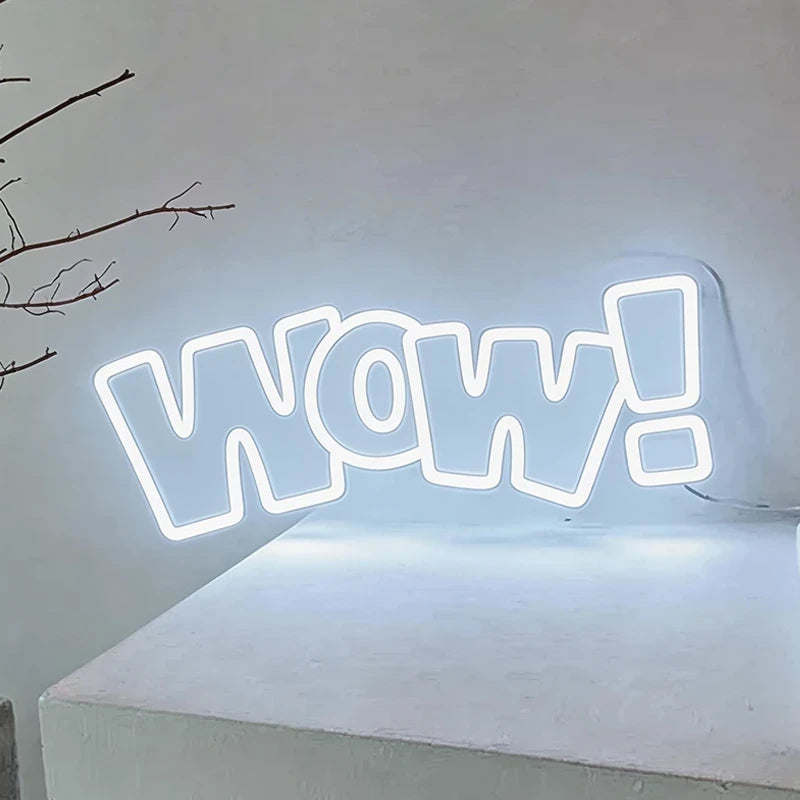 Neon sign with 'WOW!' on a white surface against a light gray background
