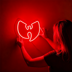 Person holding a red neon sign with a Wu-Tang Clan logo against a red background