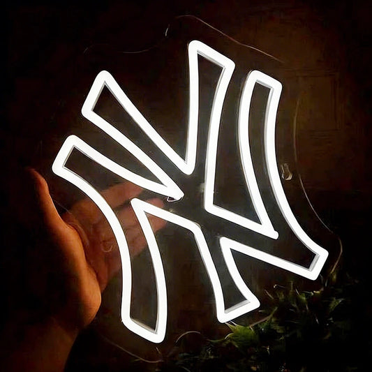 Neon sign shaped like a yankees logo with a white glow on a dark background