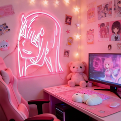 Pink-themed room with zero two anime girl neon sign, computer setup, and decorative items.
