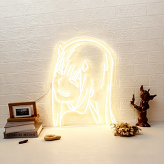Neon light shaped like zero two on a warm white textured wall with decorative items below.