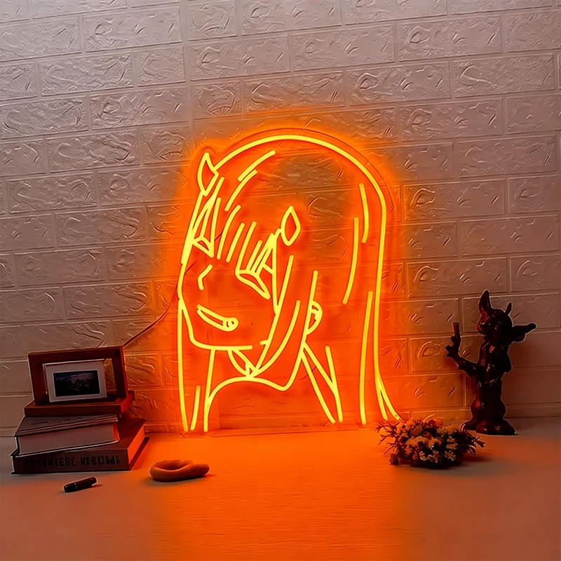 Neon sign of orange zero two on a textured brick wall with decorative items below.
