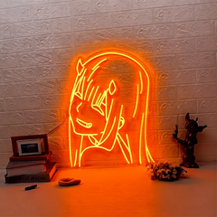 Neon sign of orange zero two on a textured brick wall with decorative items below.