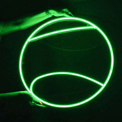 Green tennis ball neon sign glowing against a dark background