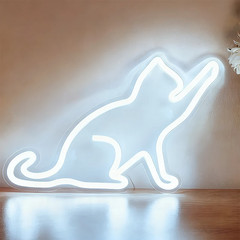 Neon white light shaped like a cat on a wooden surface with a neutral background