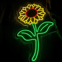 Neon light sculpture of a sunflower on a dark background