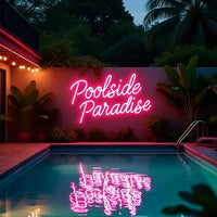 A glowing pink neon sign reading 'Poolside Paradise' mounted on a wall above a swimming pool at night, with tropical plants, poolside lighting, and the neon reflection visible in the water.