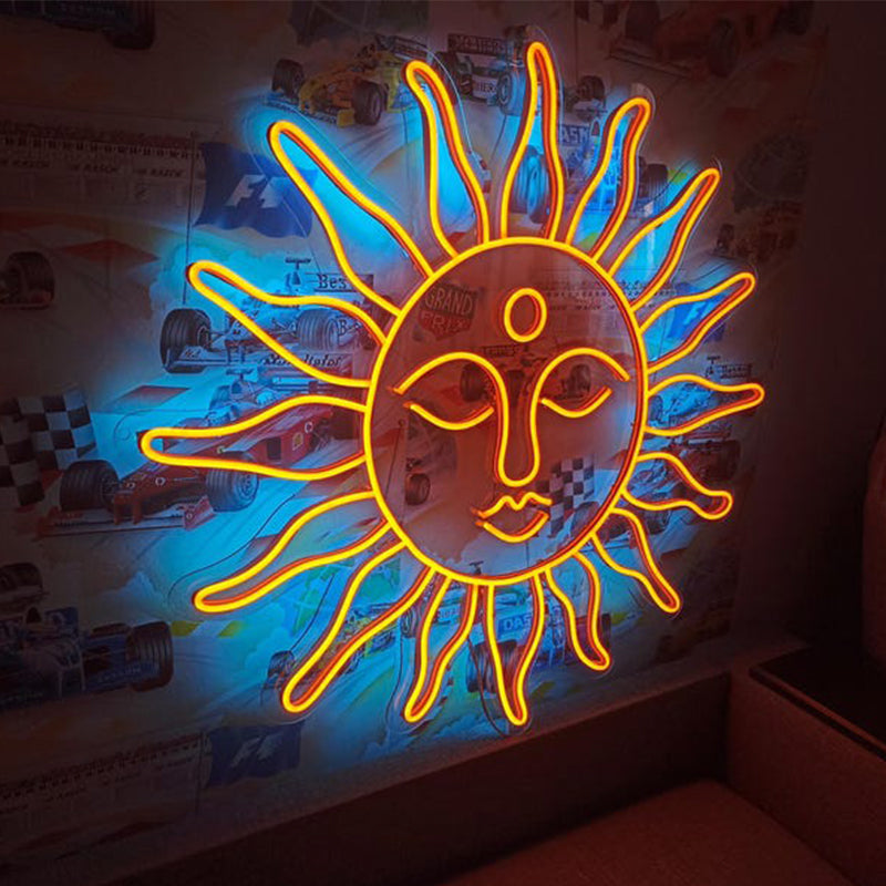 Neon sun-shaped light fixture on a wall with posters in the background