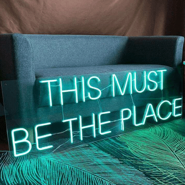 <img src='pic.png' alt=This Must Be the Place Wedding Quote Neon Sign3.' />